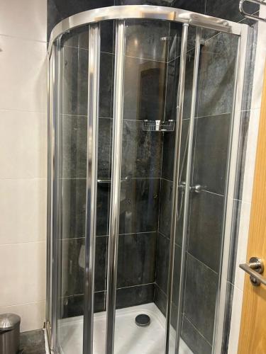 a shower with a glass door in a bathroom at Le Grand Hôtel de Thiès in Thiès