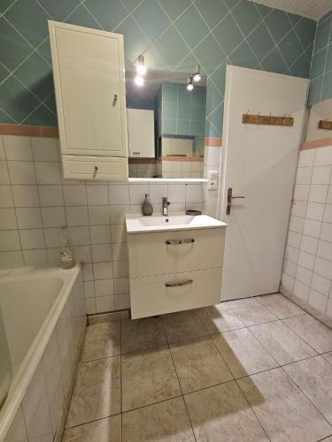 a bathroom with a sink and a toilet and a tub at Refuge Gaillard Tramway in Gaillard