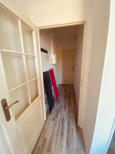 an empty hallway with a door and a room at Le Petit Condette in Condette