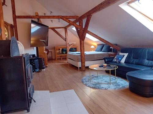 a living room with a couch and a bed at Apartmán Merkur in Kadaň