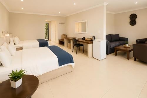 a hotel room with a bed and a living room at Royal Solwezi Hotel in Solwezi