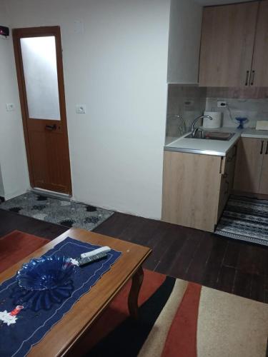 a small kitchen with a table and a counter top at Home in village in Korçë