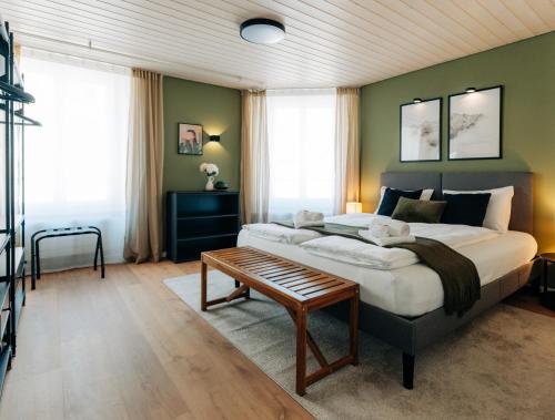 a bedroom with a large bed and a table at 120sqm Duplex Apartment with AirC Free Parking Family & Business in Biel