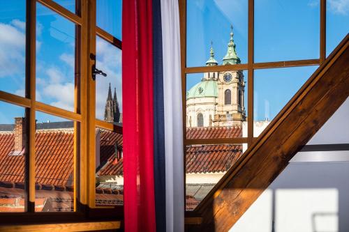 a view of a church from a window at Old Royal Post Boutique Hotel & Premium Suites in Prague