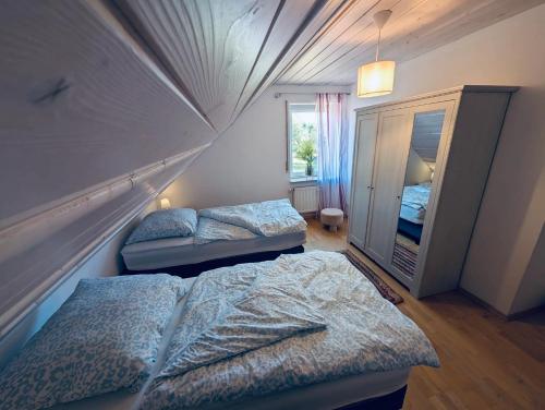a bedroom with two beds and a mirror at Ferienapartment Naturblick in Hausen