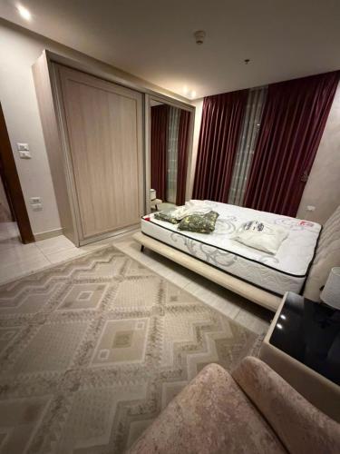 a bedroom with a bed with a rug on the floor at Nine homes in Amman