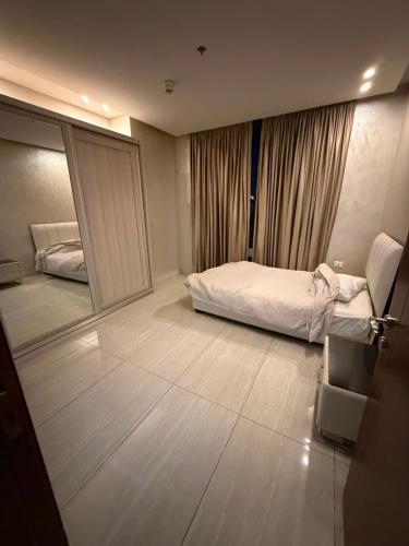 a hotel room with a bed and a mirror at Nine homes in Amman