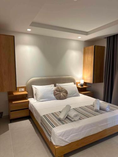 a bedroom with a large bed with towels on it at Nestia Residences in Kardamaina