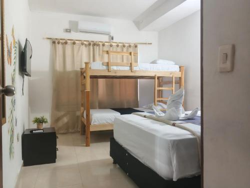 a bedroom with two bunk beds in a room at Hotel Montserrat Luxury in Valledupar
