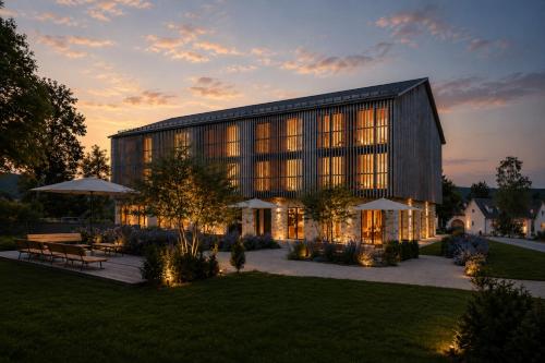 a large building with many windows at dusk at Naturhotel Die Maise in Hayingen