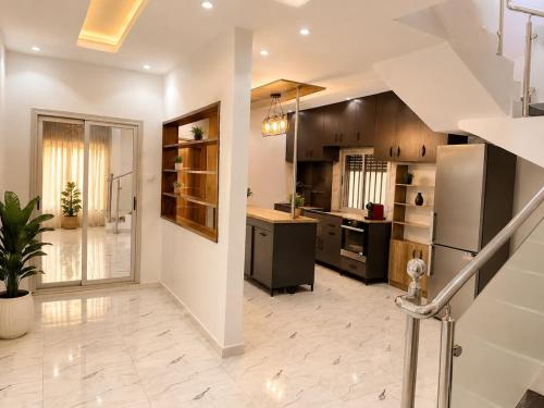 a large kitchen with a staircase in a house at house for rent in Saly Portudal