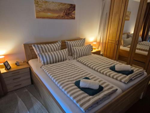a bedroom with two beds with pillows and a mirror at Ruhiges Nest in Bad Endorf