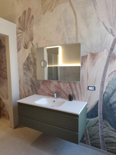 a bathroom with a sink and a mirror at Palazzo Palasciano in Monopoli