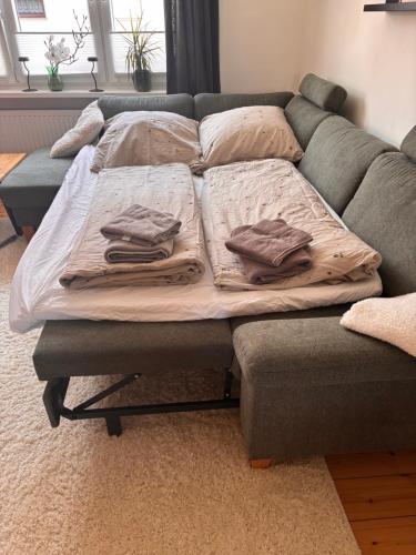 a bed on a couch with pillows on it at Ferienwohnung Rosengarten in Einbeck