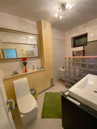 a bathroom with a sink and a mirror at RC RelaxApart 4 in Dudu