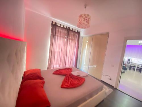 a bedroom with a bed with a red dress on it at RC RelaxApart 4 in Dudu