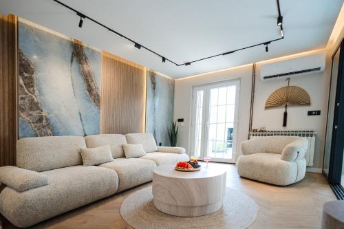 a living room with a couch and two chairs and a table at Villa The One Mostar with Heated Pool & Jacuzzi in Mostar
