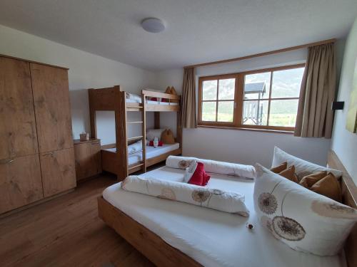 a bedroom with two beds and a window at Landhaus Eiter in Arzl im Pitztal