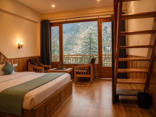 a hotel room with a bed and a large window at The Woodpecker Inn Jibhi in Jibhi