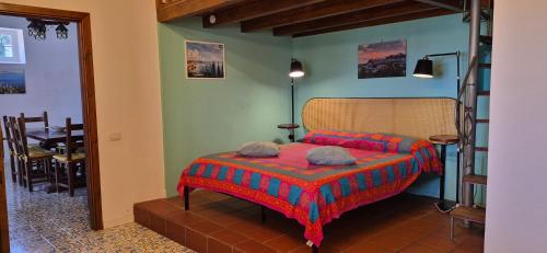 a bedroom with a bed and a dining room at Villa la Milanina in Lipari