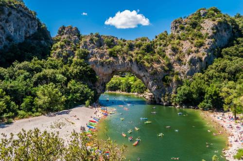 a group of people swimming in the water at a beach at Camping Ushuaïa Villages Les Cruses in Ribes
