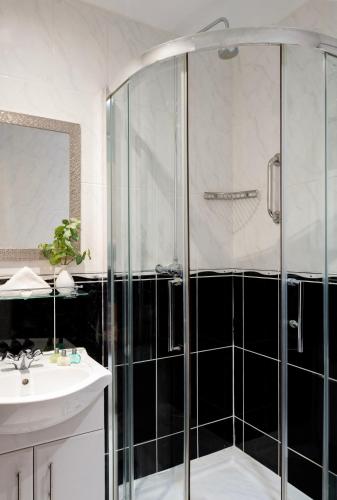 a bathroom with a shower and a sink at Langham Hotel Eastbourne in Eastbourne