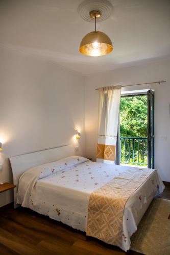 a bedroom with a large bed and a window at G&G Bed&Breakfast in Bonorva