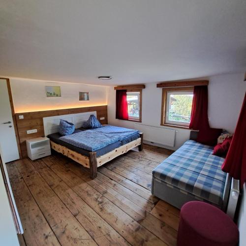 a bedroom with two beds and two windows at "Hisel-Haus" in Techelsberg am Worthersee