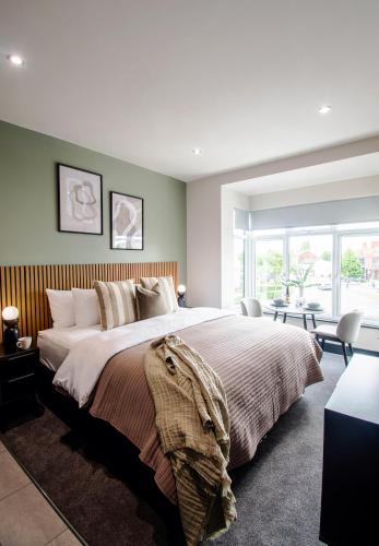 a bedroom with a large bed and a large window at The Mariner's Rest Aparthotel in Cleethorpes