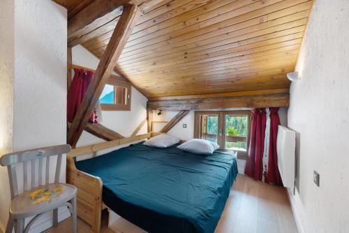 a bed in a room with a wooden ceiling at Chalet La Grange Courchevel in Courchevel