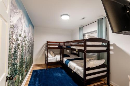 a room with two bunk beds and a blue rug at Cedar Retreat in McGaheysville