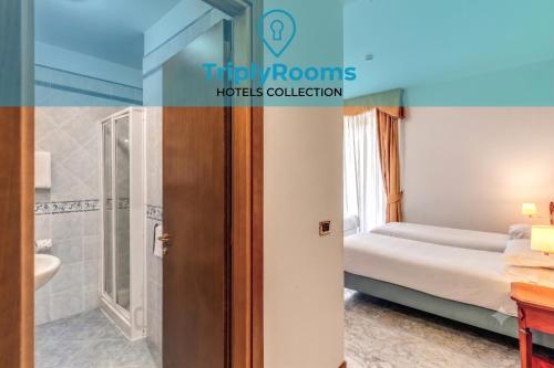 a hotel room with a bed and a bathroom at TriplyRooms Collection - Roma Colosseo in Rome