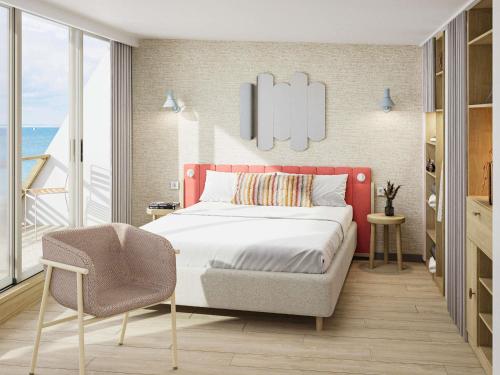 a bedroom with a red bed and a chair at Domaine des Grands Sables, Île Groix - Handwritten Collection in Groix