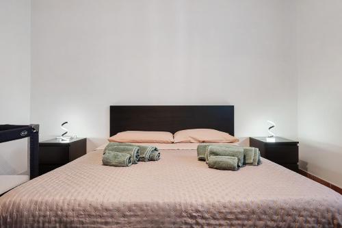 a bedroom with a large bed with two pillows on it at Dal Cappellaio Matto in Taranto
