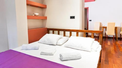 a bedroom with a bed with two towels on it at Vila Centar in Budva