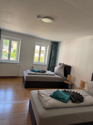 two beds in a room with two windows at Elbstone 2 in Wittenberge
