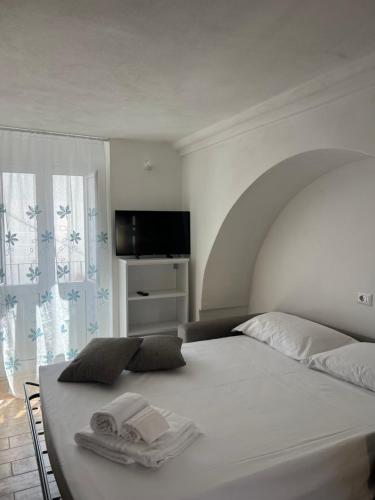a bedroom with a bed with two towels on it at Dimora Lieta in Pisticci