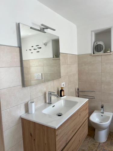a bathroom with a sink and a toilet at Dimora Lieta in Pisticci