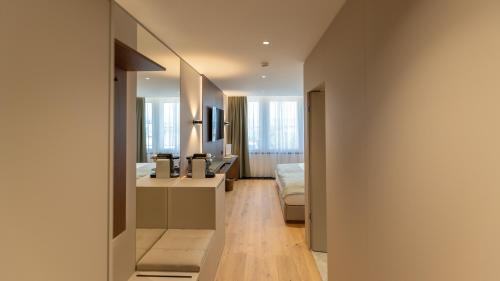 a hallway of a hotel room with a bathroom at Alpin Royal in Schaan