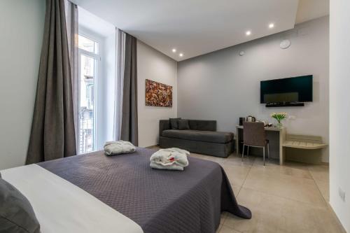 a bedroom with a bed and a living room at Toledo 16 Luxury Suites in Naples