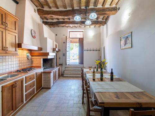 a kitchen with a wooden table and a dining room at Apartment in a farmhouse with 2 swimming pools in Cagli