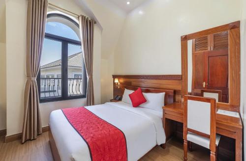 a bedroom with a bed with a desk and a window at Maro Luxury Boutique Villa - hotel in Da Thanh