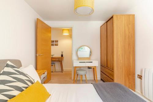 a bedroom with a bed and a desk at Fowey Landing in Fowey