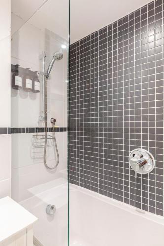 a bathroom with a shower with a glass door at Fowey Landing in Fowey