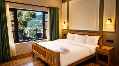 a bedroom with a bed with a large window at Summer Stays Boho in Bhīm Tāl