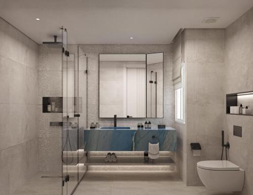 a bathroom with a shower and a blue tub at U North Coast in Sidi Kirayr