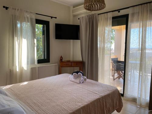 a bedroom with a bed with a towel on it at Two Mills Apartments in Myrina