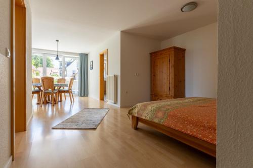a bedroom with a bed and a table and chairs at Ferienwohnung Ledergerber in Bodman-Ludwigshafen