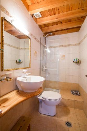 a bathroom with a sink and a toilet and a mirror at Camelot Traditional & Classic Hotel in Rhodes Town
