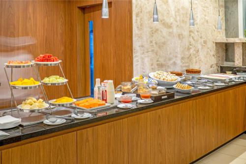 a buffet line with many different types of food at Naoum Hotel in Brasília